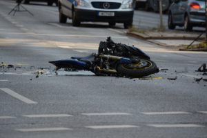 motorcycle in pieces laying in the road because of motorcycle accident